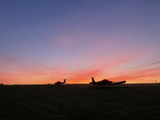 Goodnight, Dodo, by Conrad Curtis. “Spire View airfield near Salisbury is a little private farm strip which is home to<br>about 10 microlights, said Conrad. “Our syndicate aircraft is the Eurostar on the left, G-DFDO, which we call Dodo.”