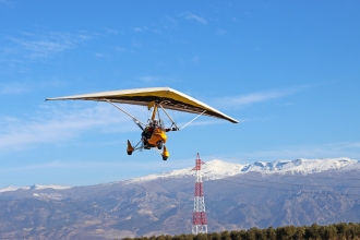 Taking flight, by Jenny Thompson. As we all know, Jenny and husband Richard decamp from Devon to Spain every winter.<br>This is Richard taking off in their Quik GTR from Juan Espadafor airfield, with a backdrop of the Sierra Nevada mountains.