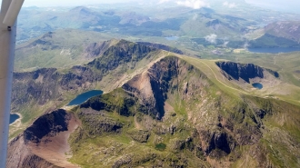 Snowdon, by Adam Balme. “Flying over the Snowdon summit on one of those rare occasions she is unguarded by cloud, captured on a recent flight from Barton to Caernarfon,” said Adam.