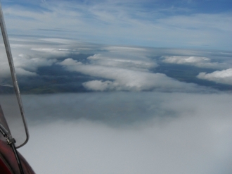 Lenticulars, by Fraser Simpson. “A hot, sunny Sunday, and it was too good to put the Quik away, so I took off from Sandy and climbed <br>well above some large cumulus clouds to enjoy the view,” said Fraser.