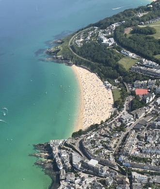 Porthmeor Beach, by Eddie McCallum. Eddie flying past a very busy sun-soaked Porthmeor Beach in Cornwall in his much-travelled CTSW.